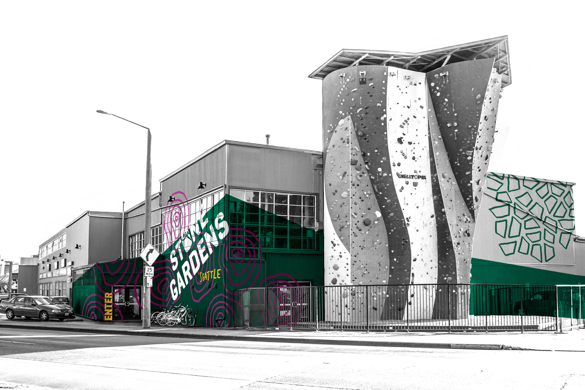 an image of the new Stone Gardens brand applied to their Seattle gym location exterior. A green, textured polygonal building wrap gives the impression of a mountain.